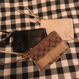 Set of 3 Coach wristlets- blk, gold and white.